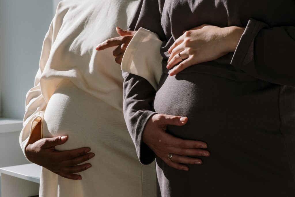 Close-up of two pregnant women embracing the beauty of motherhood.